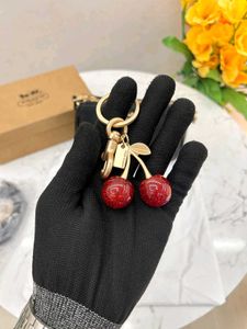 Coach Black Leather Camera Bag with Cherry Charm