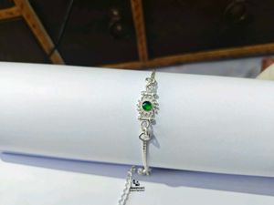 Elegant Pure Silver Rakhi with Green Stone