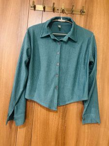 This is a teal-green pleated long-sleeve collared