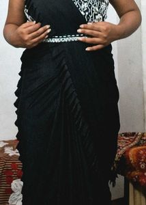Selling a black color partywear stitched saree