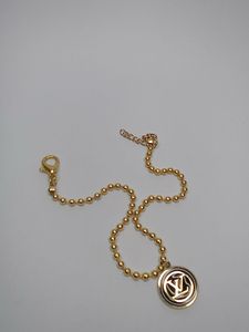 Elegant Gold Beaded Bracelet with Charm