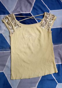 yellow crop top with silver detailing on sleves