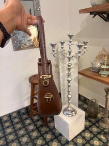 brown sling bag with belt