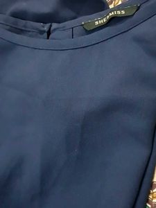 Navy blue top with knot in lower side