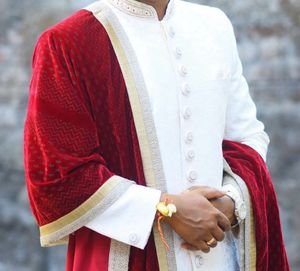 Men’s white sherwani with red velvet dhoti
