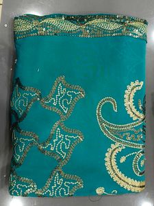 Elegant Teal Saree with Gold Embellishments