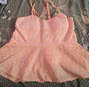 orange coloured sleeveless top