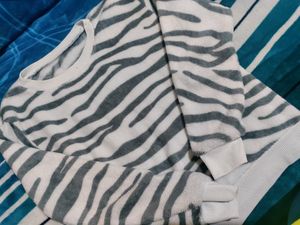 White Velvet Sweater With Black Stripes On It