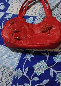 Stylish Red Handbag with Embellishments
