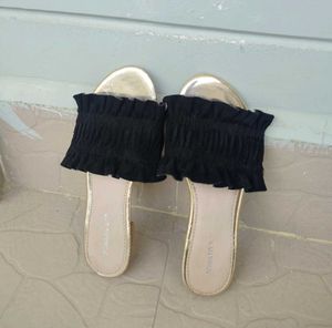 Chic Black Smocked Sandals with a Gold toned sole
