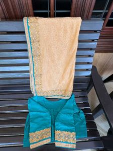 cream colour saree with peacock blue blouse