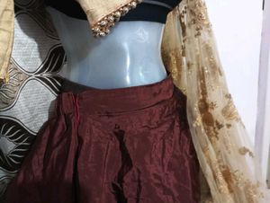 dark brown lehga with golden duppatta and blouse