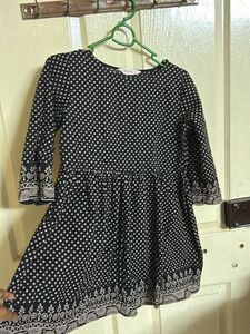 A Black with Beige polka dots top