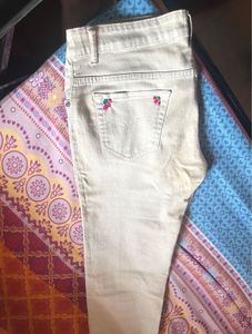 Stylish Beige Jeans with Floral Detail