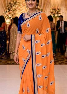 Orange Saree with Blue Velvet Blouse