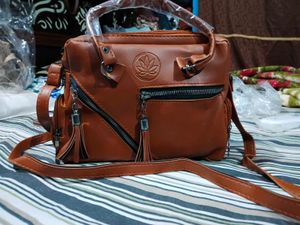 Stylish Tan Leather Handbag with Tassel Detail