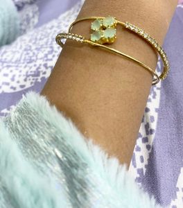 Elegant Gold-Tone Bangle with Gemstones