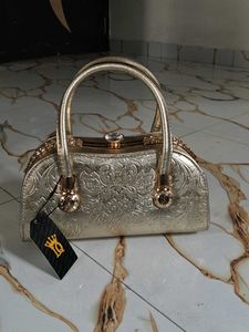 Elegant Gold Clutch with Gemstone Accent