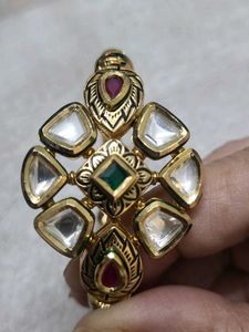 Elegant Gold Bangle with Green Stones