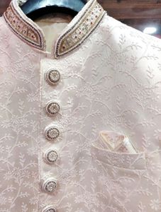 Men’s white sherwani with red velvet dhoti
