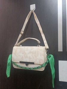 Chic Cream Textured Handbag with Green Scarf Accen