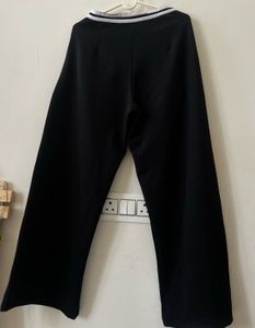 Black trousers with white stripe detail