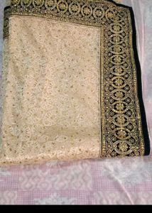 Elegant Cream Saree with Gold Embellishments