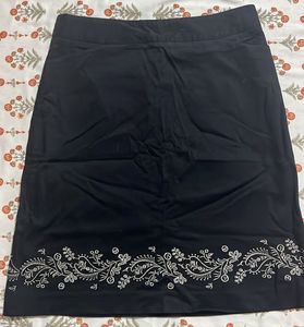 Chic Black Skirt with Embroidered Hem