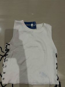 White sleeveless top with lace up detail