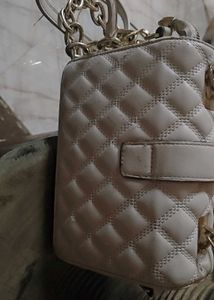 Beige sling bag along with chain slin
