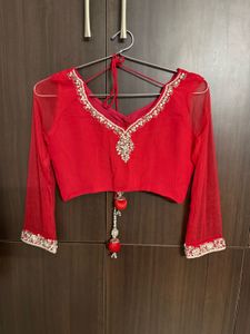 Vibrant Red Saree with Intricate Embellishments