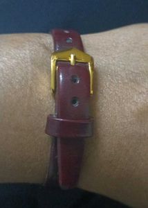 Elegant Gold Tone Watch with Burgundy Band