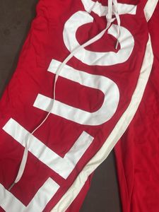 Red Wide-Leg Pants with Bold White Text