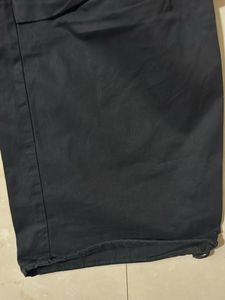 Black trendy parachute pants with adjustable lows