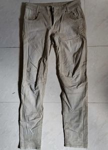 Mufti jeans in a light beige or khaki color featur