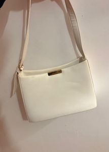 White Handbag With A Golden Buckle