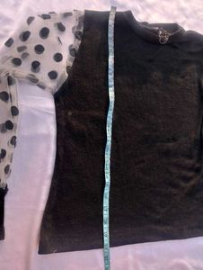 Chic Black Top with Polka Dot Sleeves
