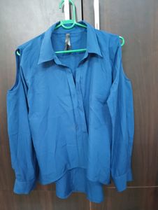 Royal Blue Top With Cold Shoulder Style. Can Be Styled Up For Office And Party Both. Bottom Style Of the Top Is High Low Style.