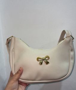 Chic Cream Hobo Bag with Gold Bow Accent