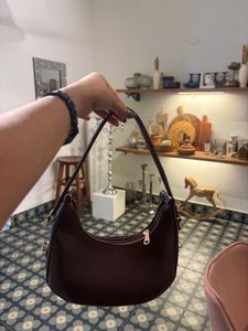 brown sling bag with belt