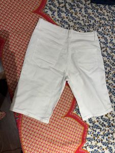 A pair of sexy white distressed shorts