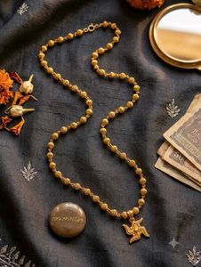 Elegant Gold Beaded Necklace with Swastik