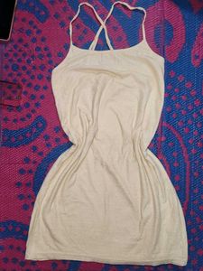 Cream-colored (or off-white) mini dress