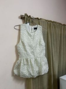 The ivory peplum top