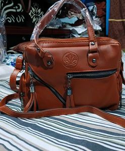 Stylish Tan Leather Handbag with Tassel Detail