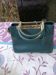 Stylish Teal Handbag with Gold Accents
