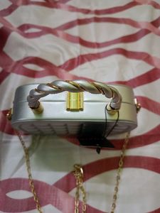 Elegant Silver Clutch with Gold Chain