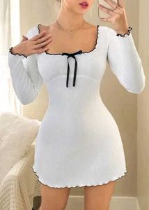 Chic Ribbed White Mini Dress with Bow Detail