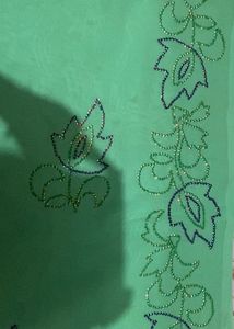 A Light Green Saree With Hand Work