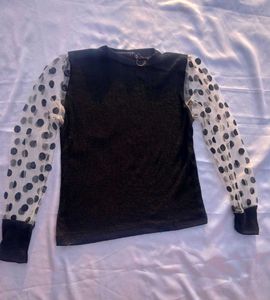 Chic Black Top with Polka Dot Sleeves